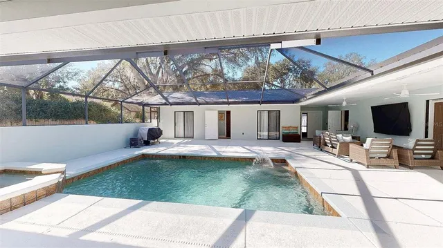 a view of a patio with swimming pool table and chairs
