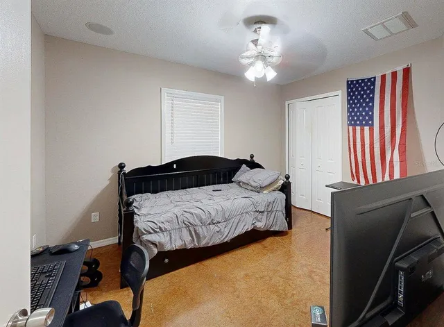 a bedroom with a bed and a chandelier