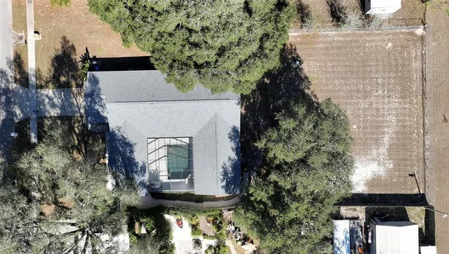 an aerial view of a house with a yard