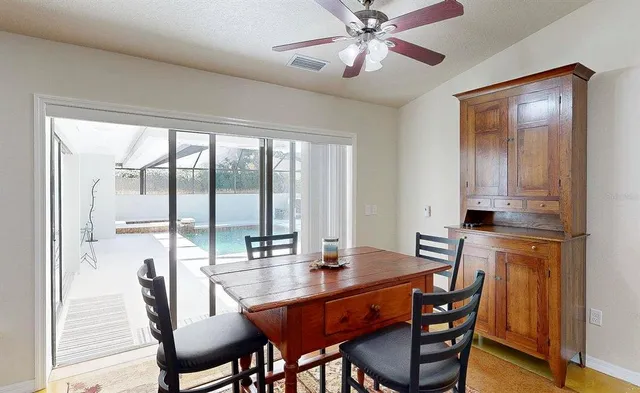 a dining room with furniture window and wooden floor