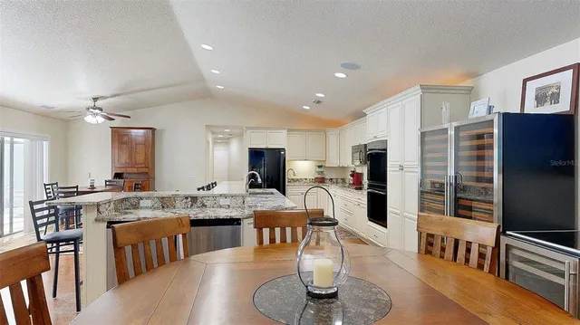 a large kitchen with a table and chairs