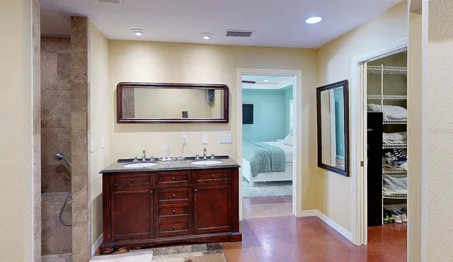 a bathroom with a sink a mirror and a shower