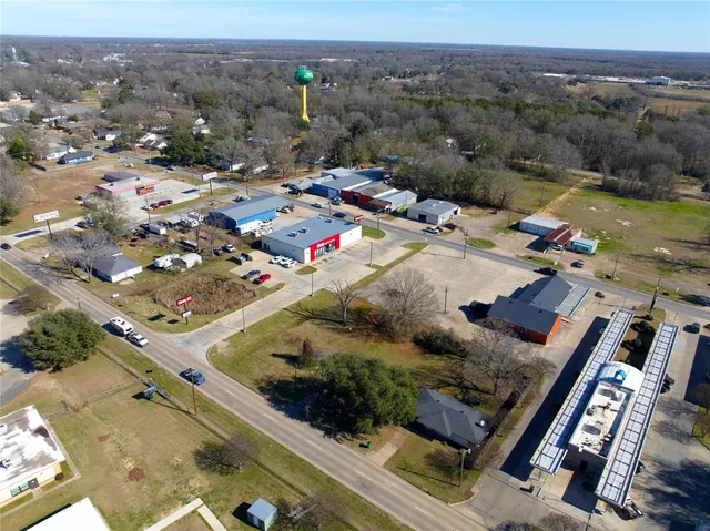 a view of a yard with a house in the background