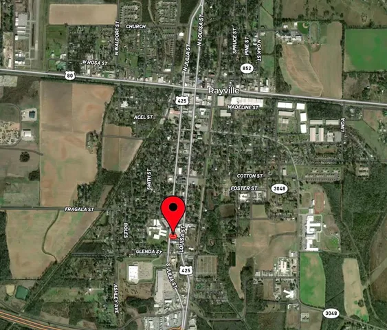 a view of a water fountain in front of residential houses