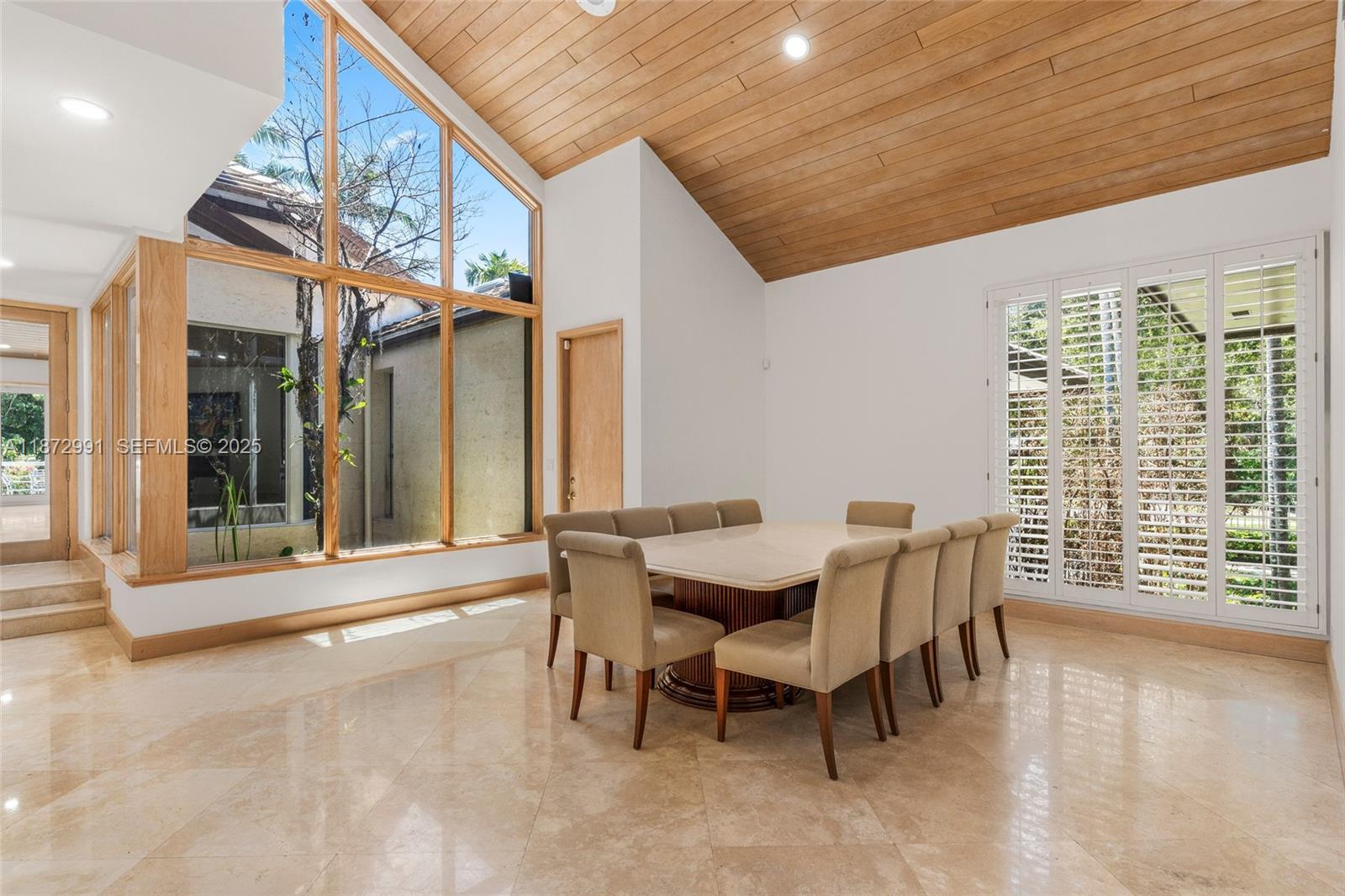 6190 Southwest 102nd Street Pinecrest, FL 33156 - Photo 16 of 52 a dining room with furniture and wooden floor