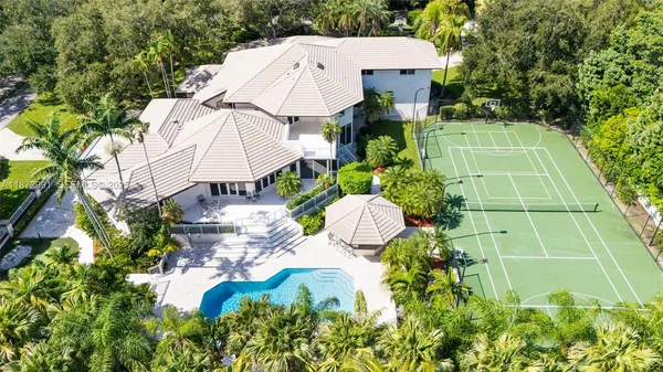 a view of a house with a yard and sitting area