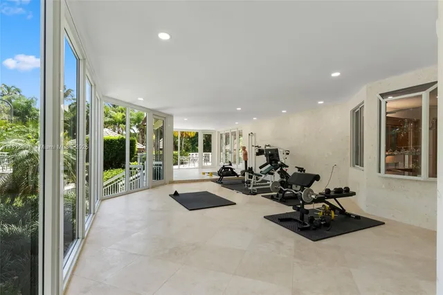 a view of a room with gym equipment and floor to ceiling window