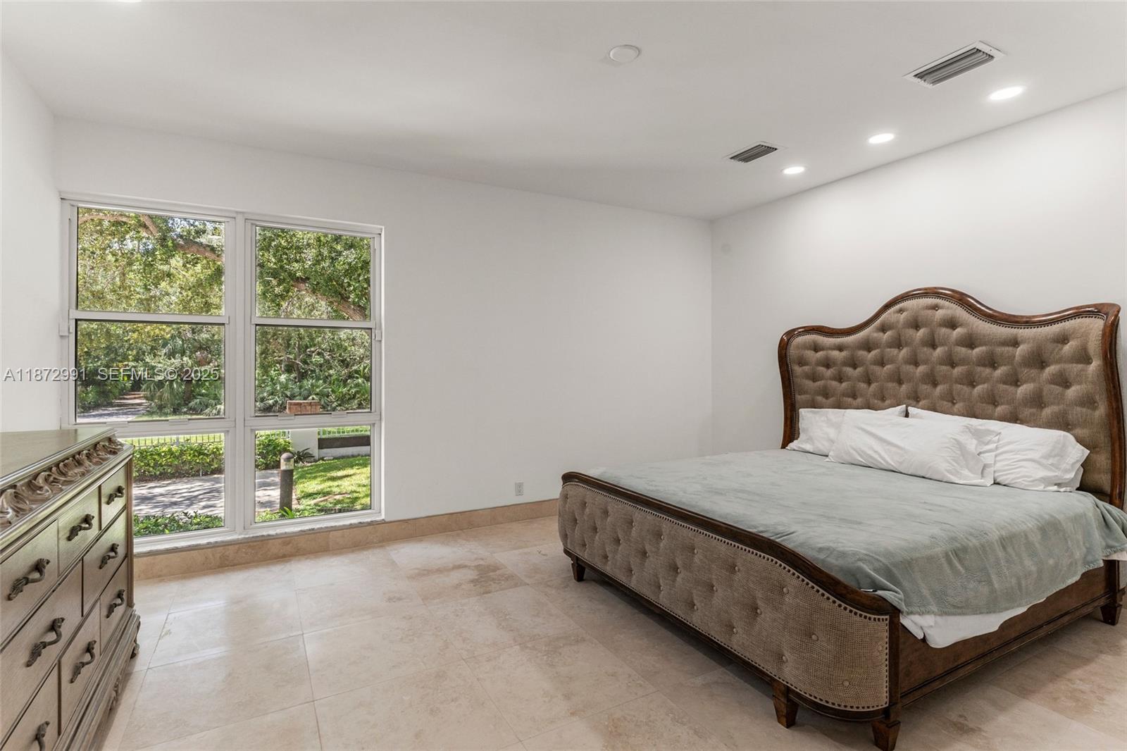 6190 Southwest 102nd Street Pinecrest, FL 33156 - Photo 32 of 52 a bedroom with a bed and a window