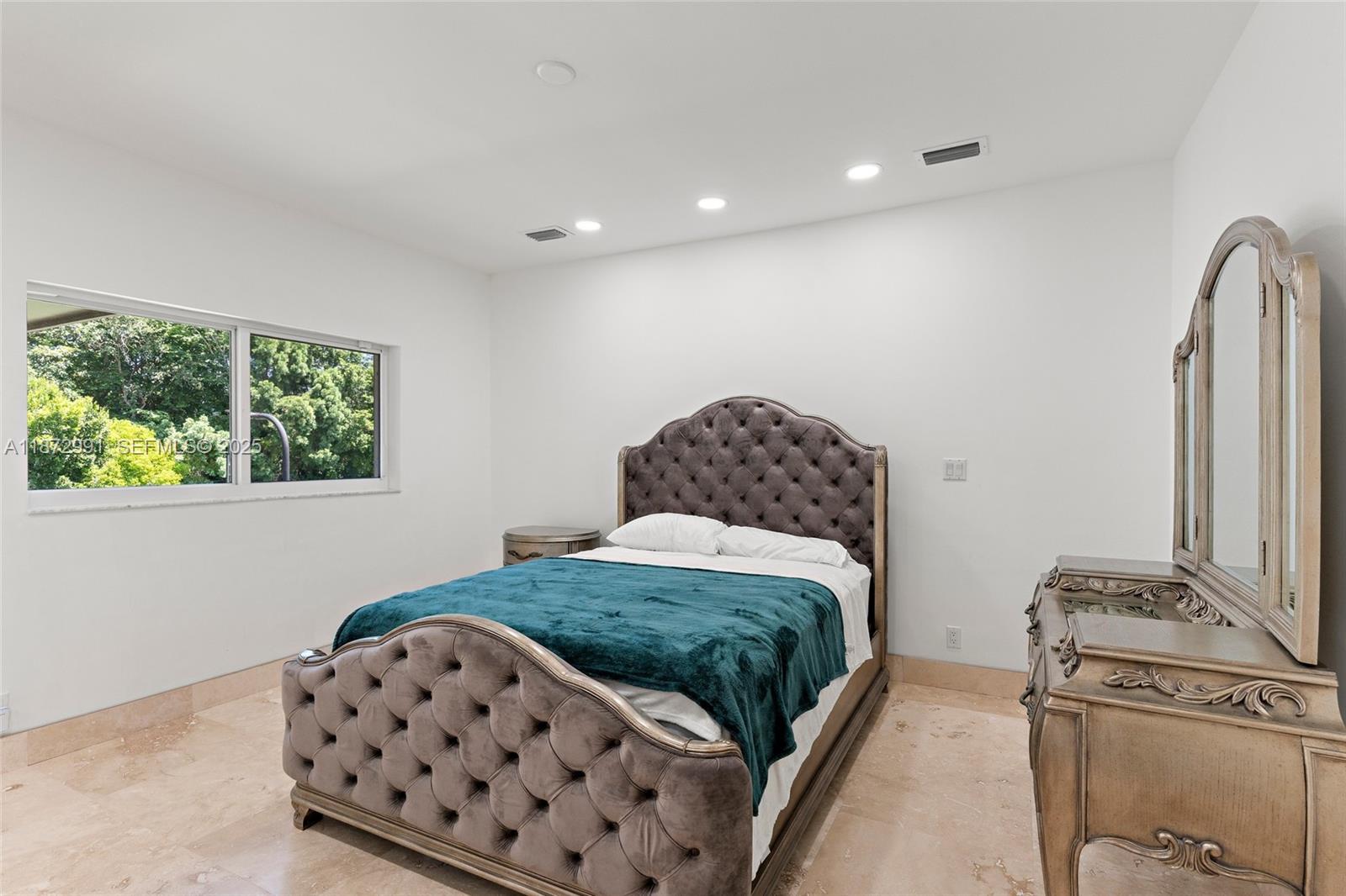 6190 Southwest 102nd Street Pinecrest, FL 33156 - Photo 34 of 52 a bedroom with a bed and a window