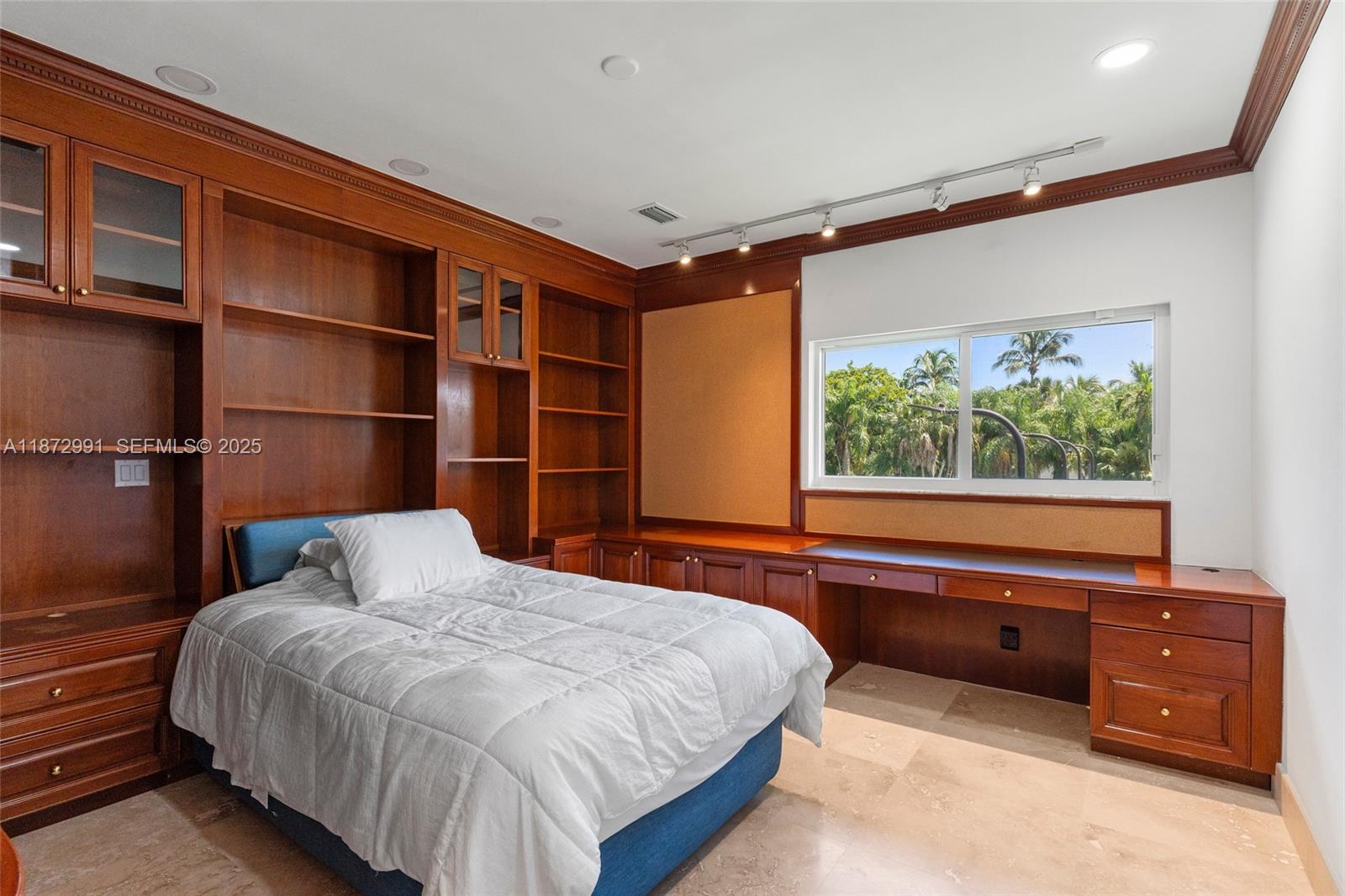 6190 Southwest 102nd Street Pinecrest, FL 33156 - Photo 36 of 52 a bedroom with a large bed and a window