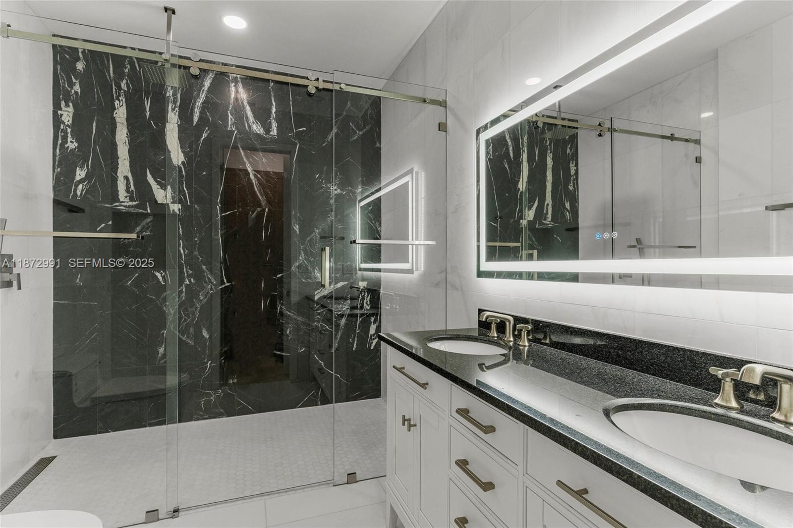 6190 Southwest 102nd Street Pinecrest, FL 33156 - Photo 37 of 52 a bathroom with a shower sink and mirror