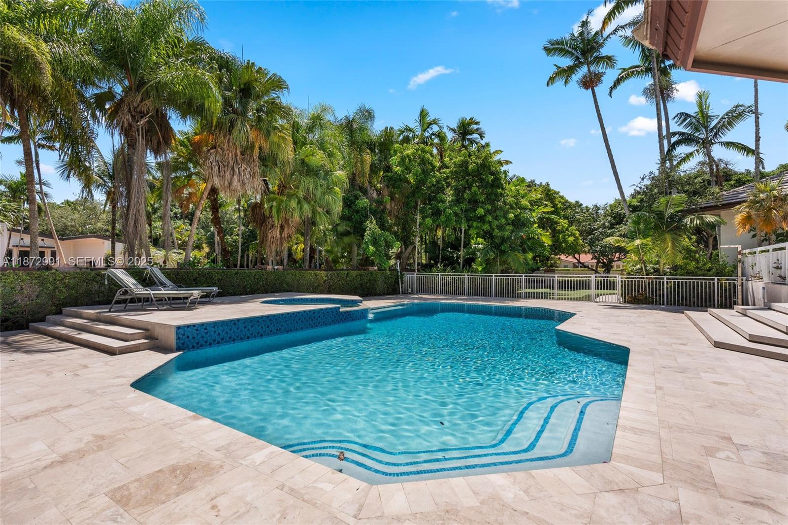 6190 Southwest 102nd Street Pinecrest, FL 33156 - Photo 42 of 52 a view of a swimming pool with a patio