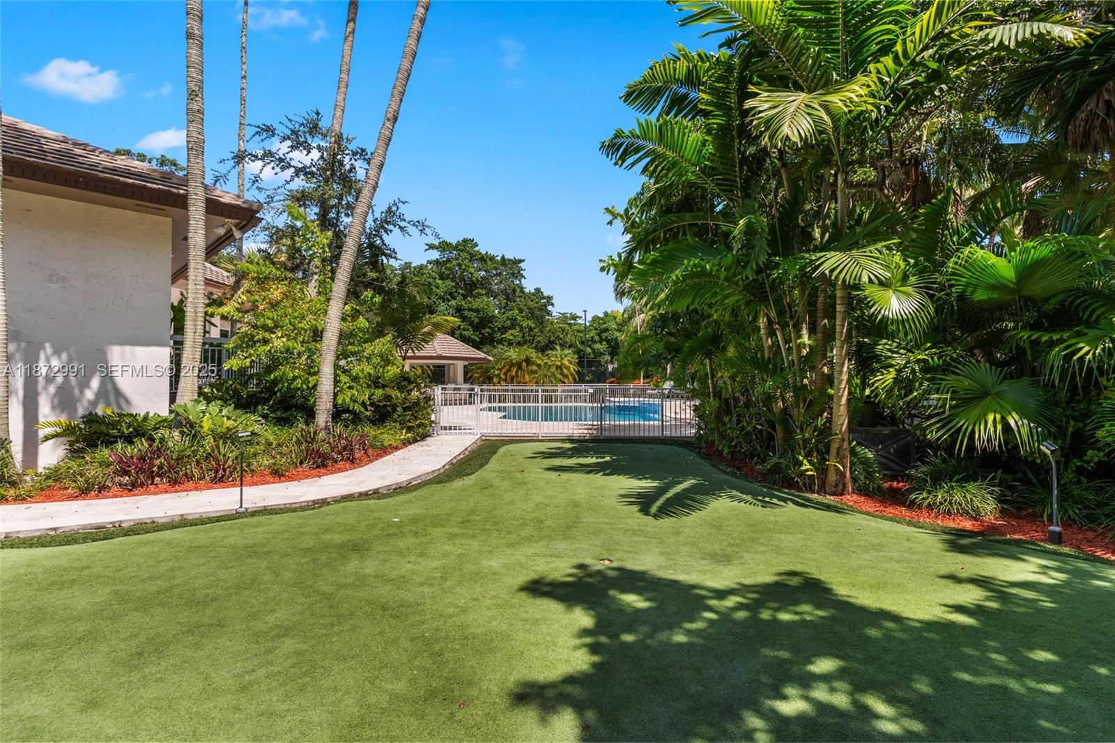 6190 Southwest 102nd Street Pinecrest, FL 33156 - Photo 44 of 52 a view of a garden with a slide