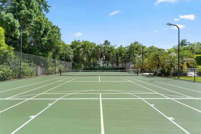 an aerial view of a house with swimming pool and garden