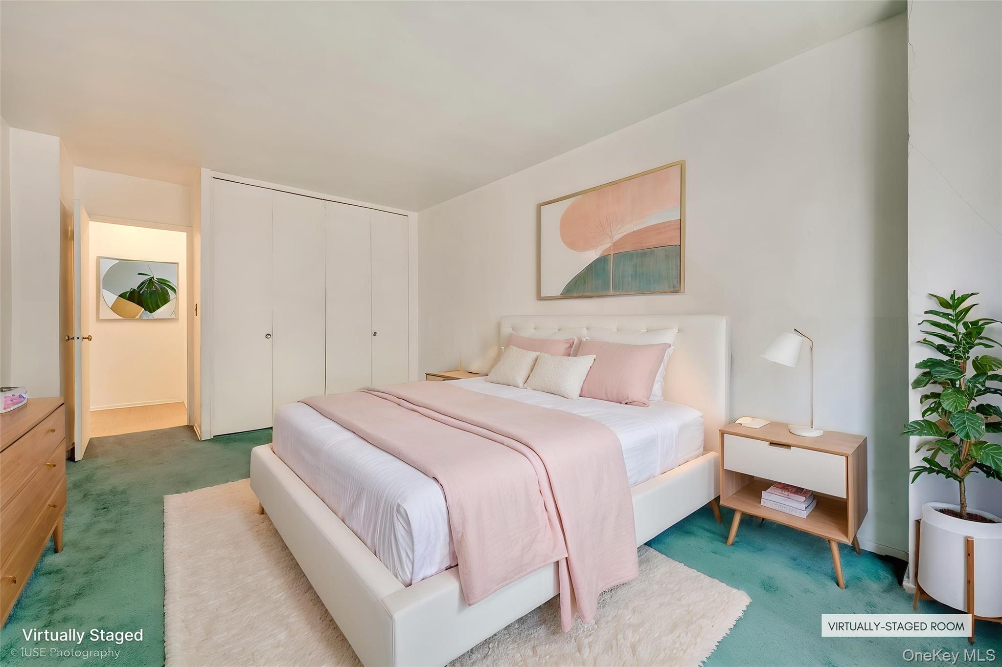39-65 52nd Street, Unit 2H Queens, NY 11377 - Photo 4 of 18 a spacious bedroom with a bed and a potted plant