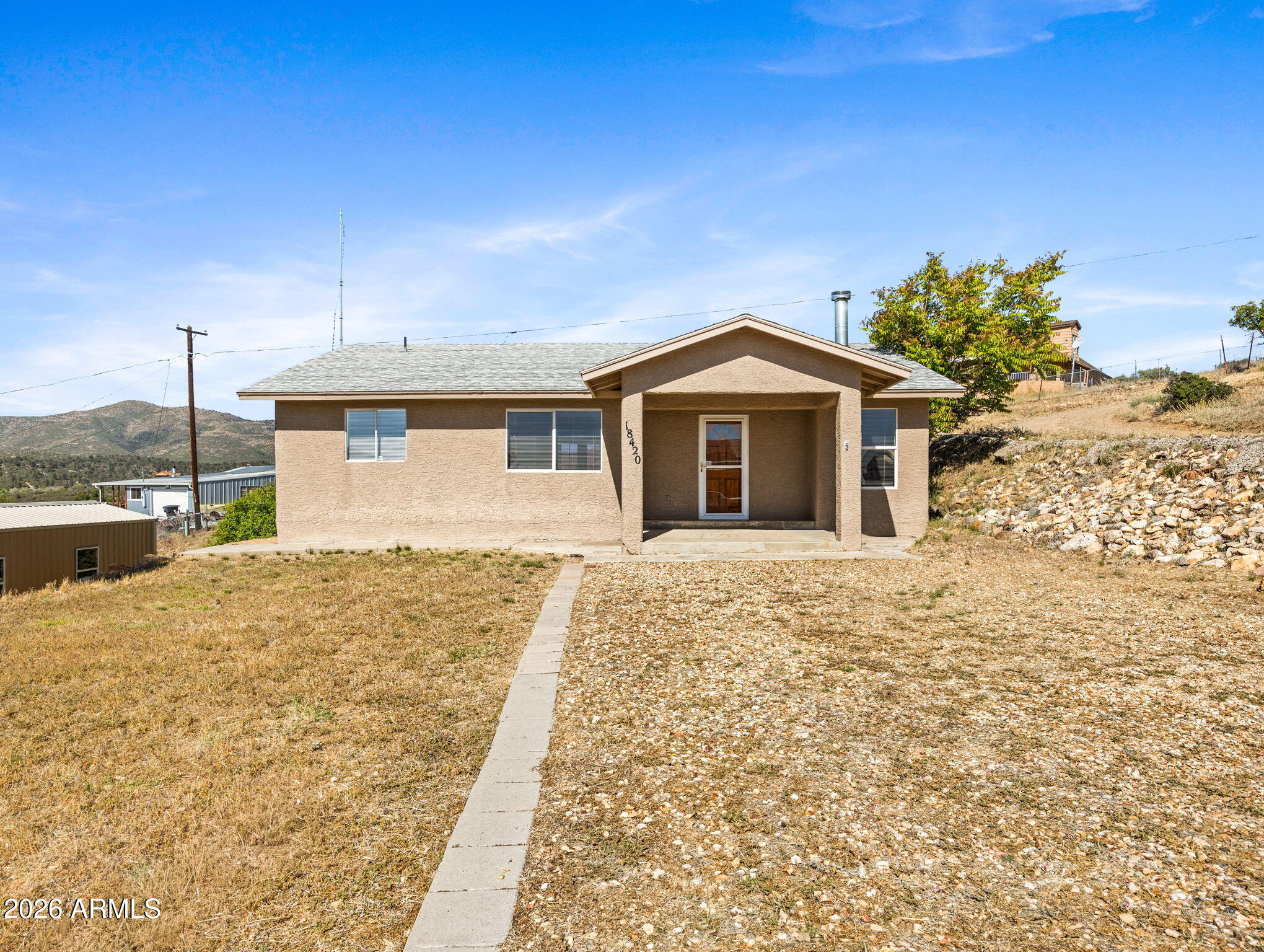 18420 Peeples Valley Road Peeples Valley, AZ 86332 - Photo 29 of 31 a front view of a house with a yard