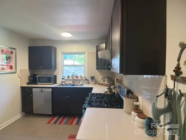 a living room with granite countertop furniture a rug and a window