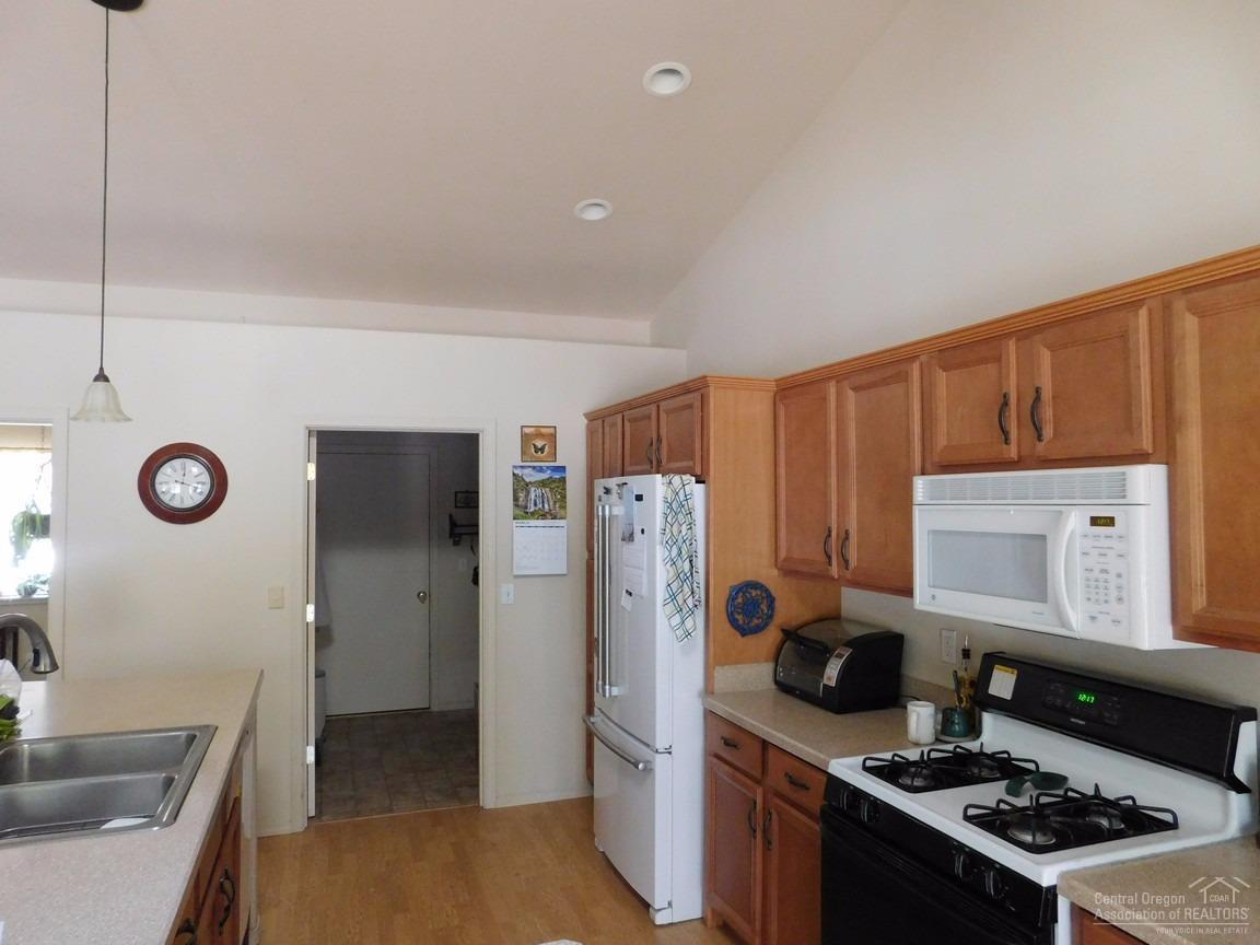 16984 Glendale Road Bend, OR 97707 - Photo 6 of 24 a kitchen with stainless steel appliances granite countertop a stove and a refrigerator