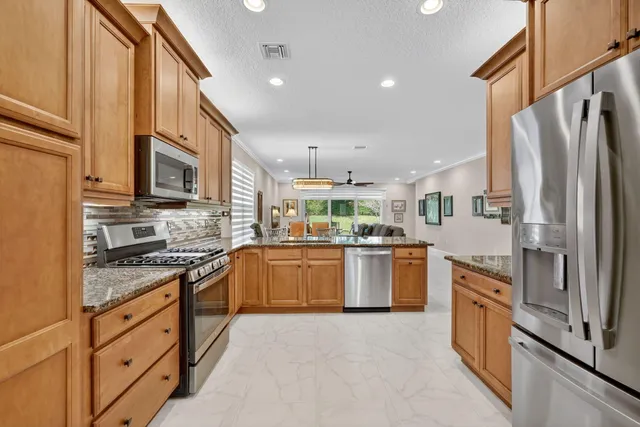 a living room with furniture and a view of kitchen
