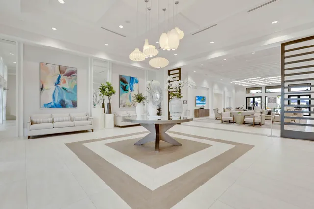 a living room with furniture chandelier and a large window