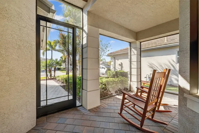 a kitchen with stainless steel appliances granite countertop a refrigerator a stove a sink dishwasher a dining table and chairs with wooden floor