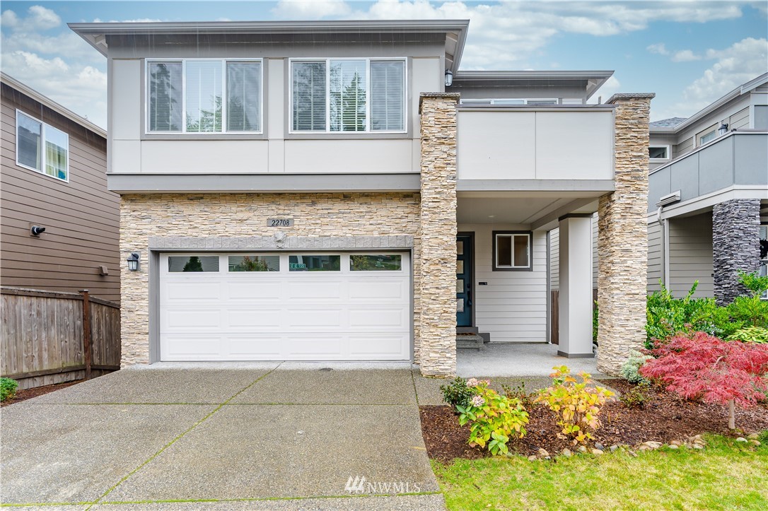 22708 41st Drive Southeast Bothell, WA 98021 - Photo 1 of 37 a front view of a house with a yard and garage