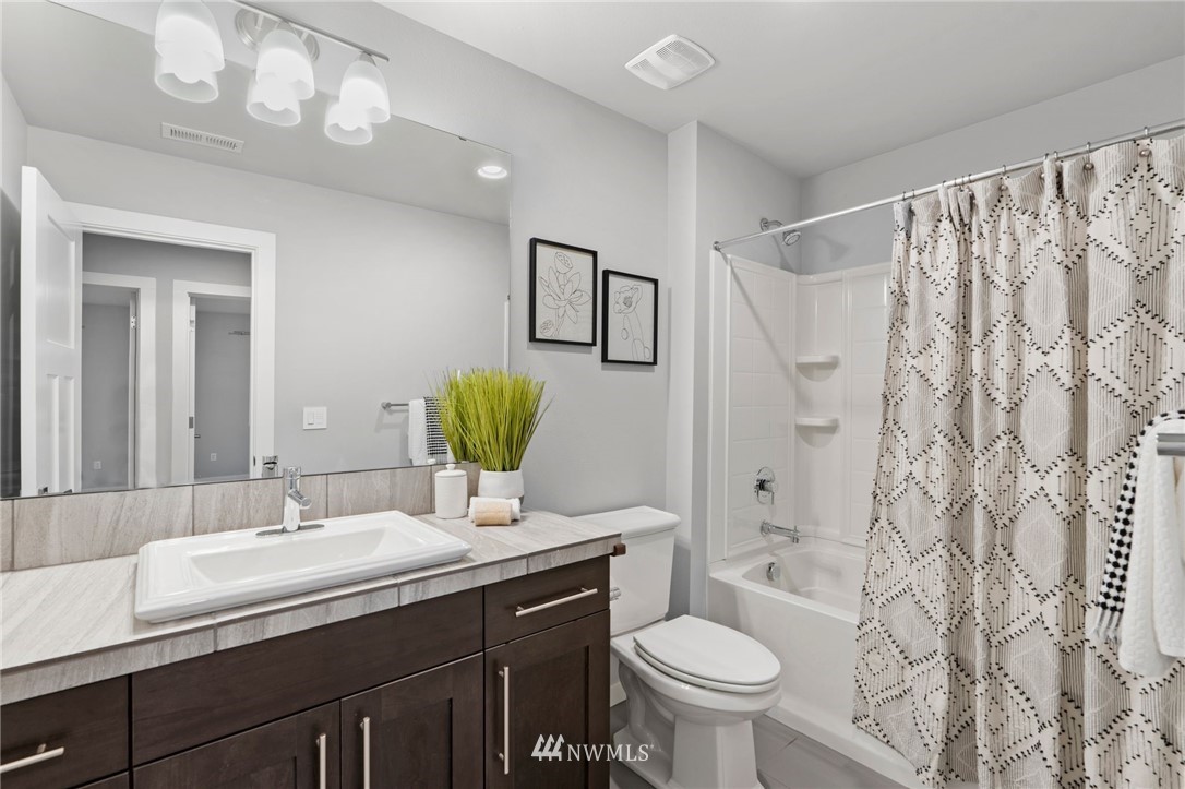 22708 41st Drive Southeast Bothell, WA 98021 - Photo 24 of 37 a bathroom with a double vanity sink toilet and a mirror