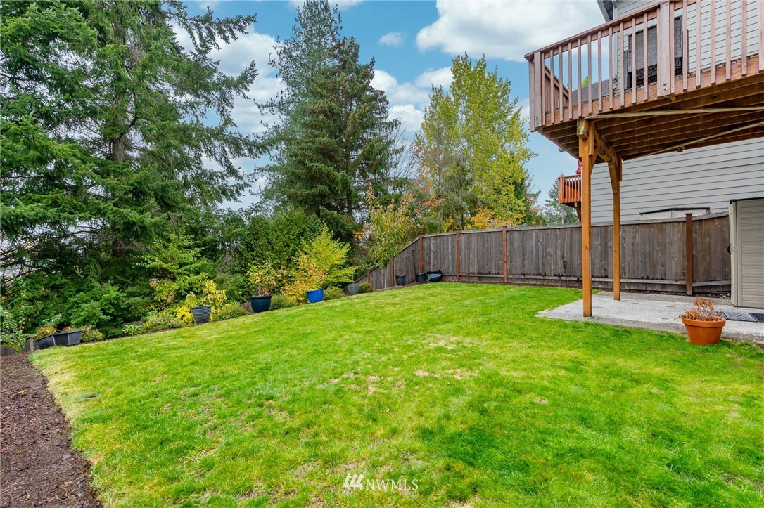 22708 41st Drive Southeast Bothell, WA 98021 - Photo 34 of 37 a view of a backyard with table and chairs and wooden fence