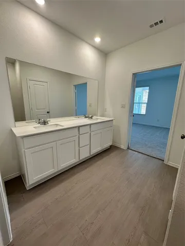 a bathroom with a double vanity sink and mirror