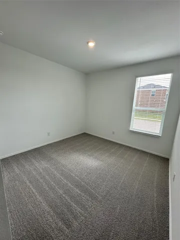 a large white kitchen with a large window