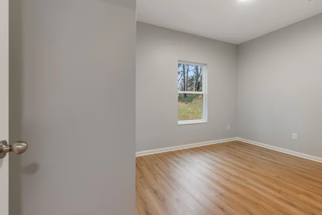 a view of room with window and hardwood floor
