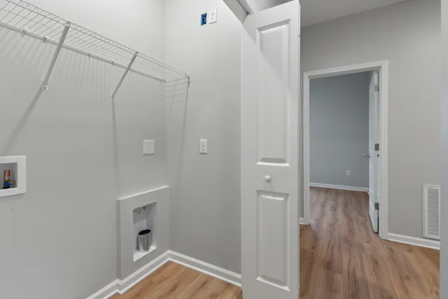 a view of a room with wooden floor