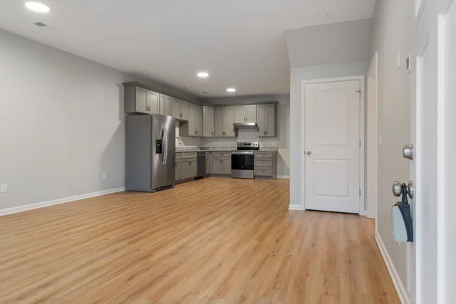 a view of a kitchen with a sink and refrigerator