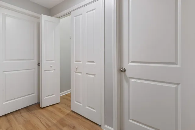 a view of a room with wooden floor