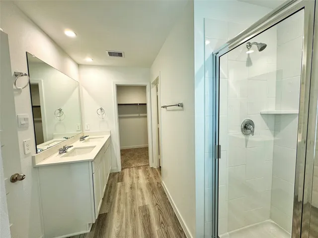 a bathroom with a glass shower door