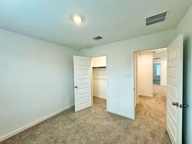 an empty room with closet area