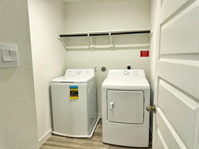 a front view of a house with yard and wooden fence