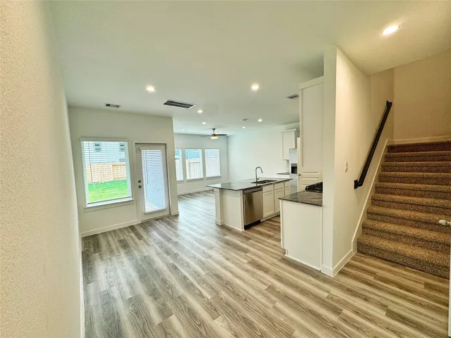 a view of kitchen and hall with wooden floor