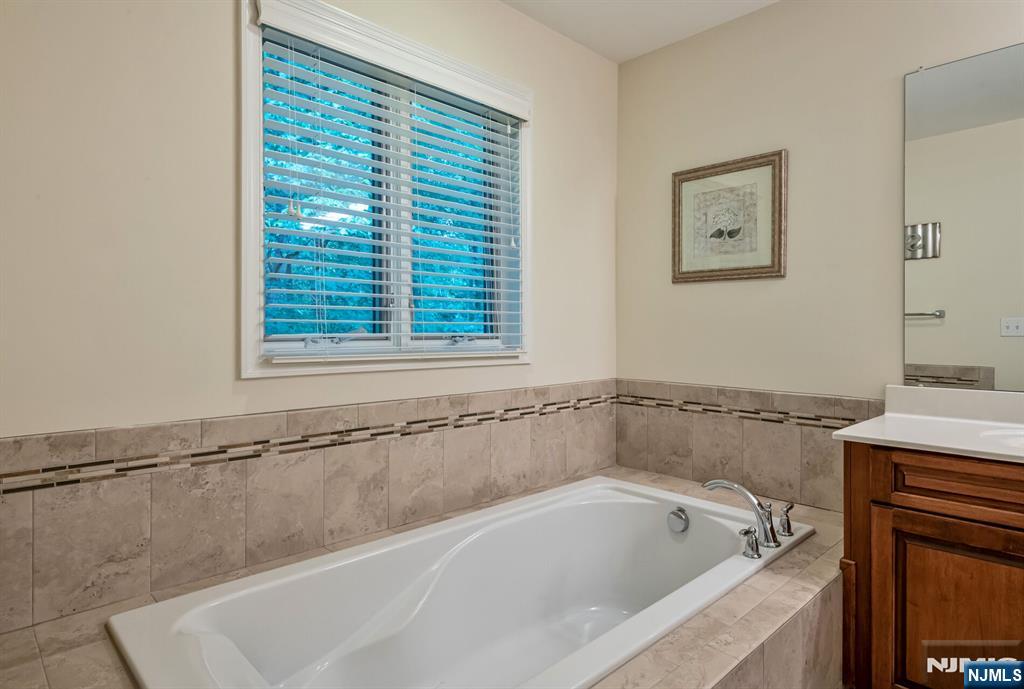 1508 Whitney Lane, Unit 1508 Allendale, NJ 07401 - Photo 11 of 24 a white bath tub sitting next to a window