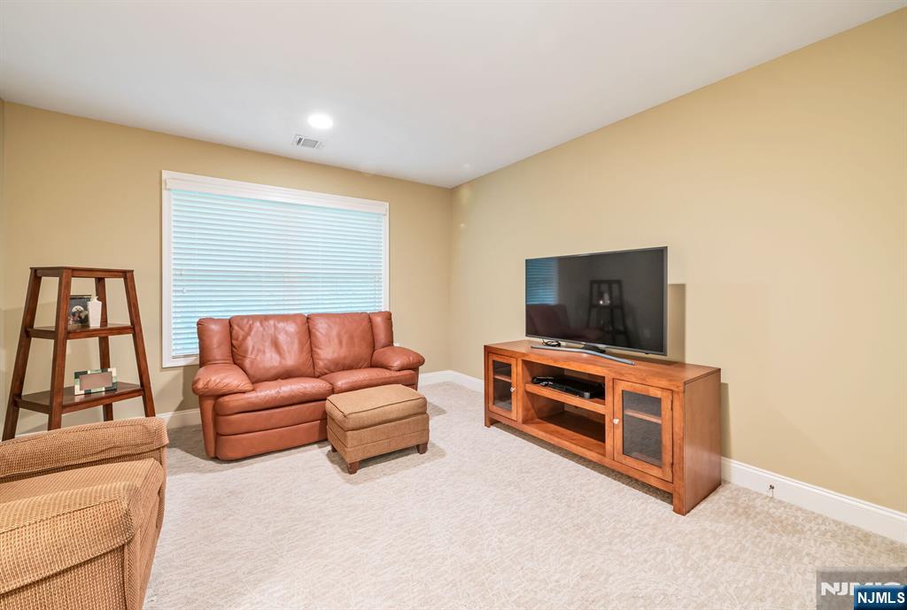 1508 Whitney Lane, Unit 1508 Allendale, NJ 07401 - Photo 14 of 24 a living room with furniture and a flat screen tv