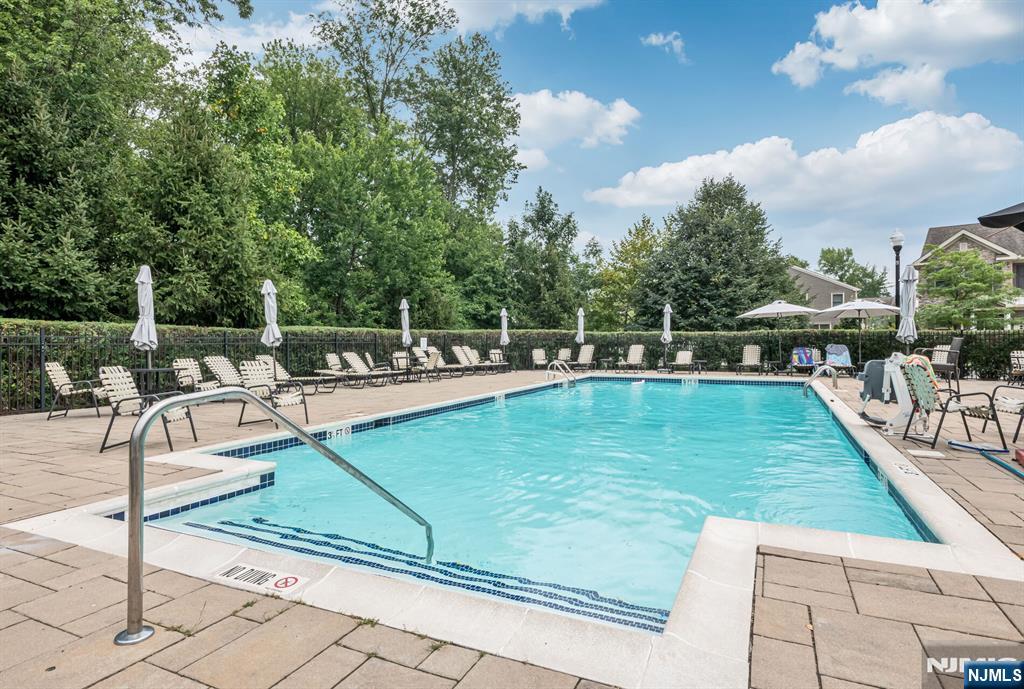 1508 Whitney Lane, Unit 1508 Allendale, NJ 07401 - Photo 19 of 24 a view of a swimming pool with chairs