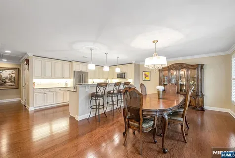 a view of a dining room with furniture wooden floor and chandelier