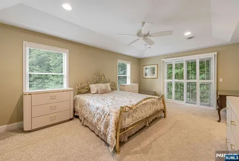 a bed room with a bed and a large window