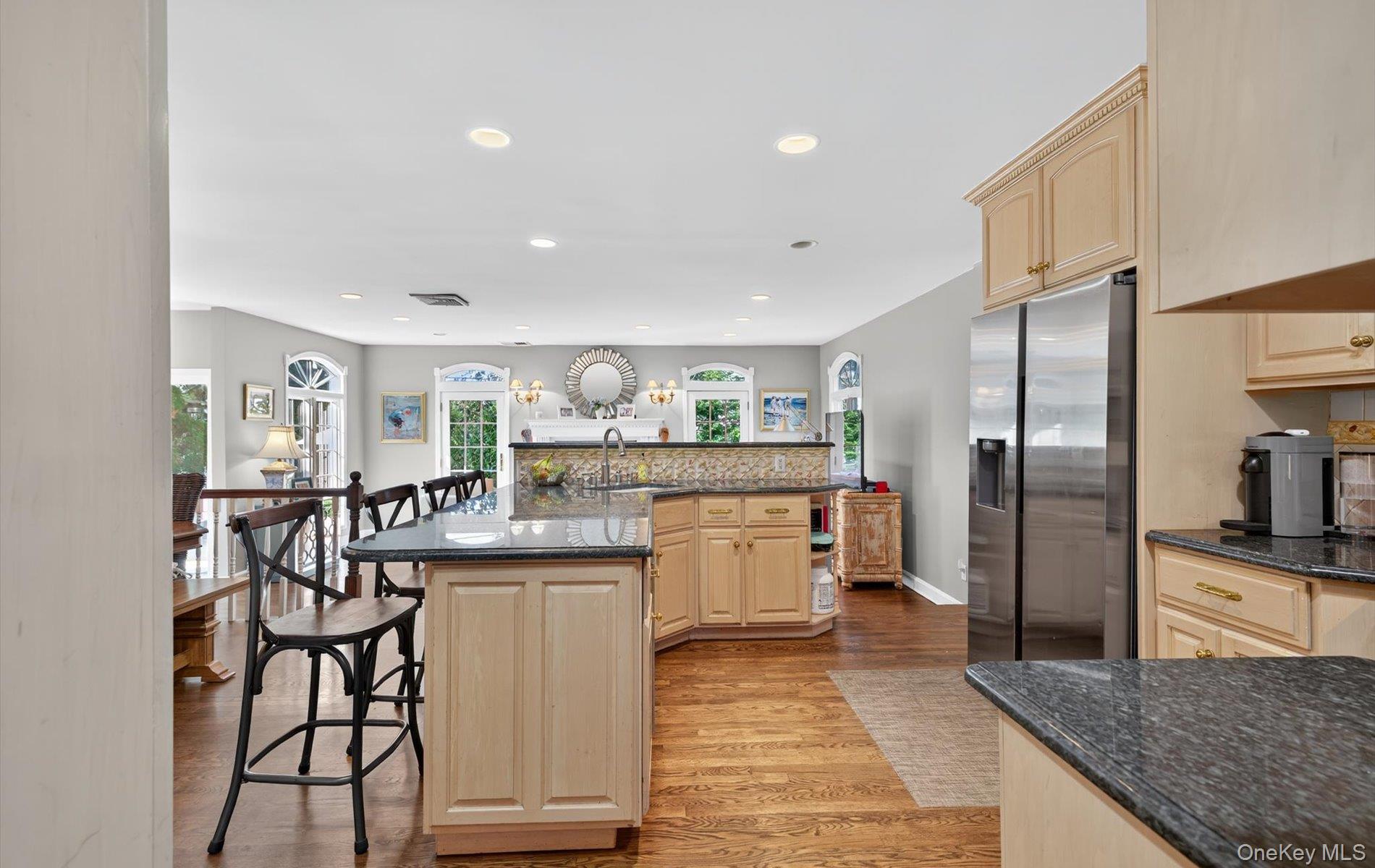53 Eakins Road Manhasset, NY 11030 - Photo 11 of 34 a kitchen with refrigerator and chairs