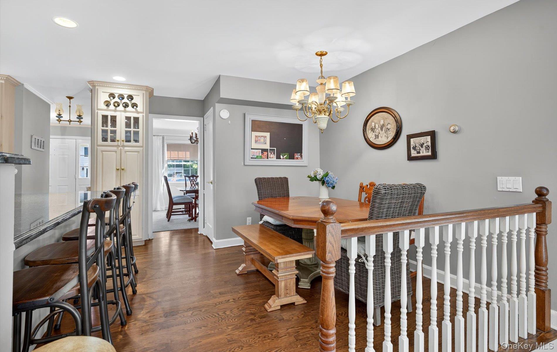 53 Eakins Road Manhasset, NY 11030 - Photo 12 of 34 a view of a dining room with furniture a chandelier and wooden floor
