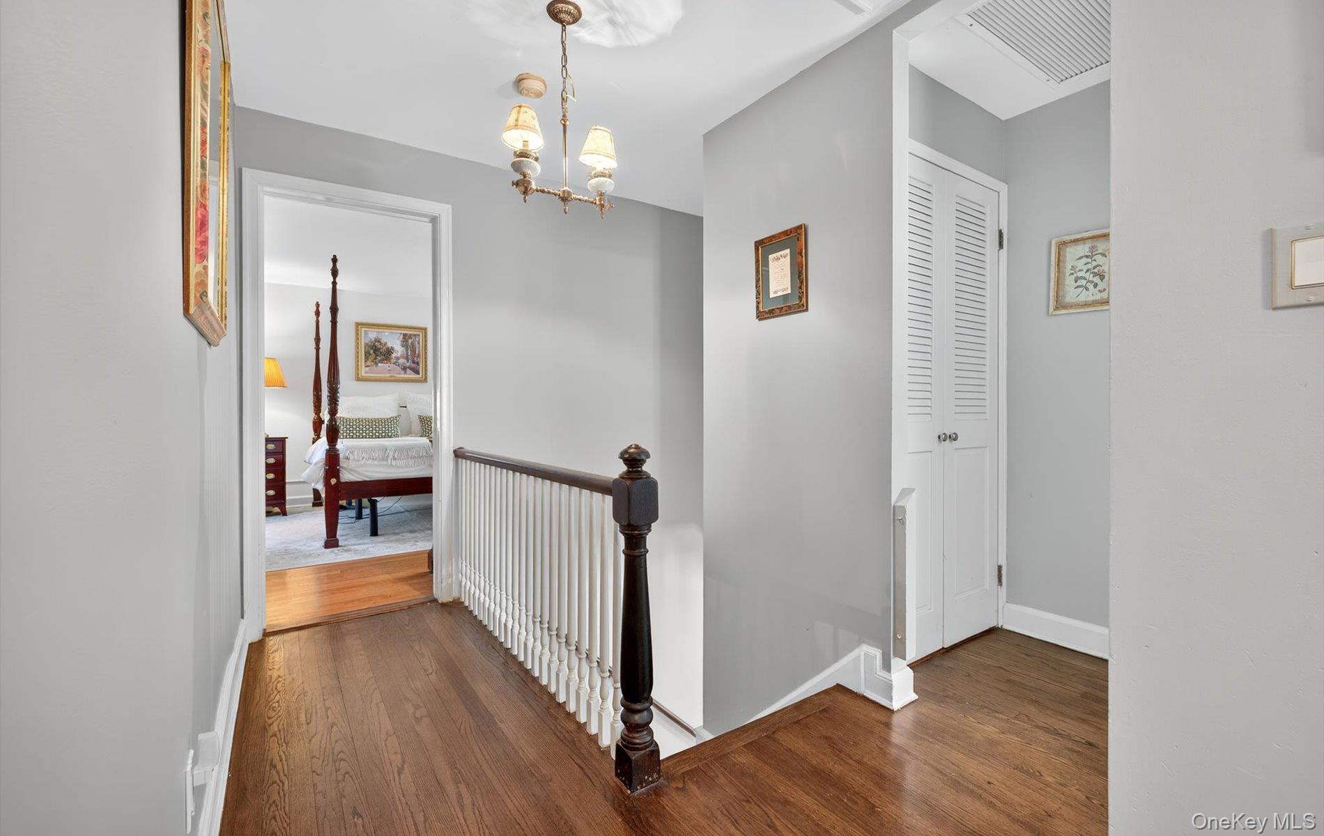 53 Eakins Road Manhasset, NY 11030 - Photo 19 of 34 a view of a hallway view with wooden floor and staircase