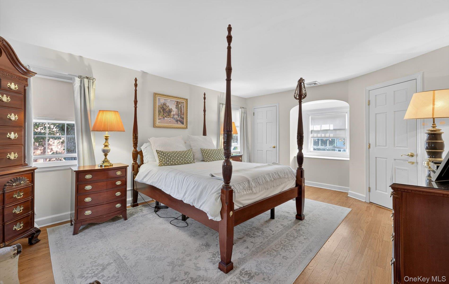 53 Eakins Road Manhasset, NY 11030 - Photo 20 of 34 a bedroom with a bed lamps and window