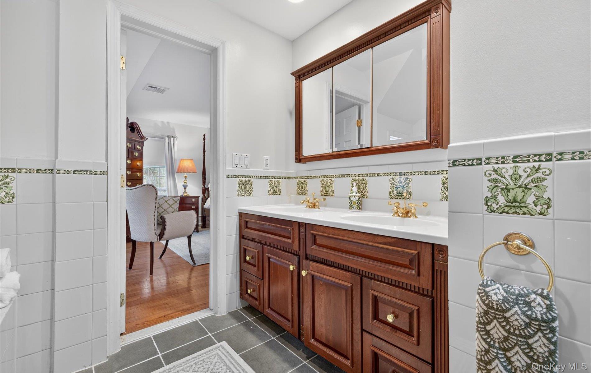 53 Eakins Road Manhasset, NY 11030 - Photo 22 of 34 a bathroom with a sink a mirror and a shower