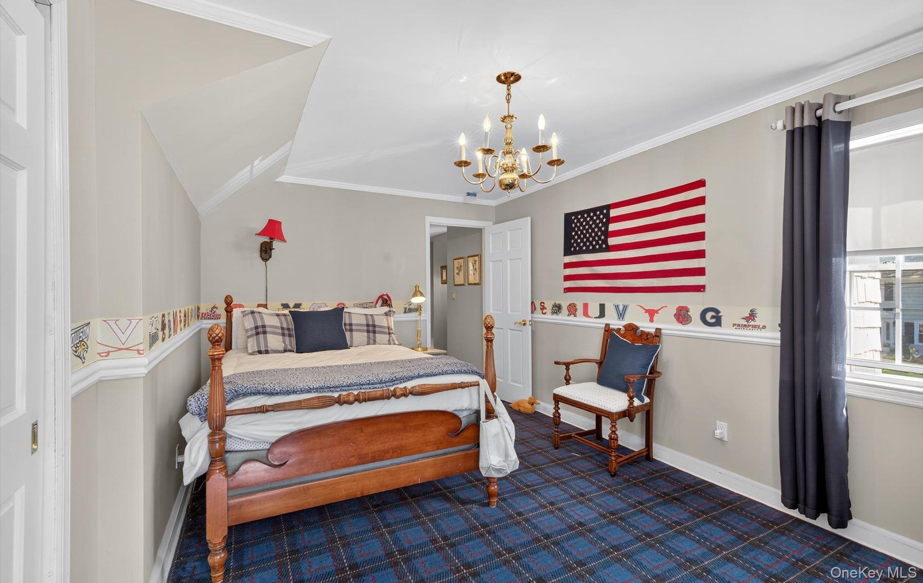 53 Eakins Road Manhasset, NY 11030 - Photo 25 of 34 a bedroom with a bed and a chandelier