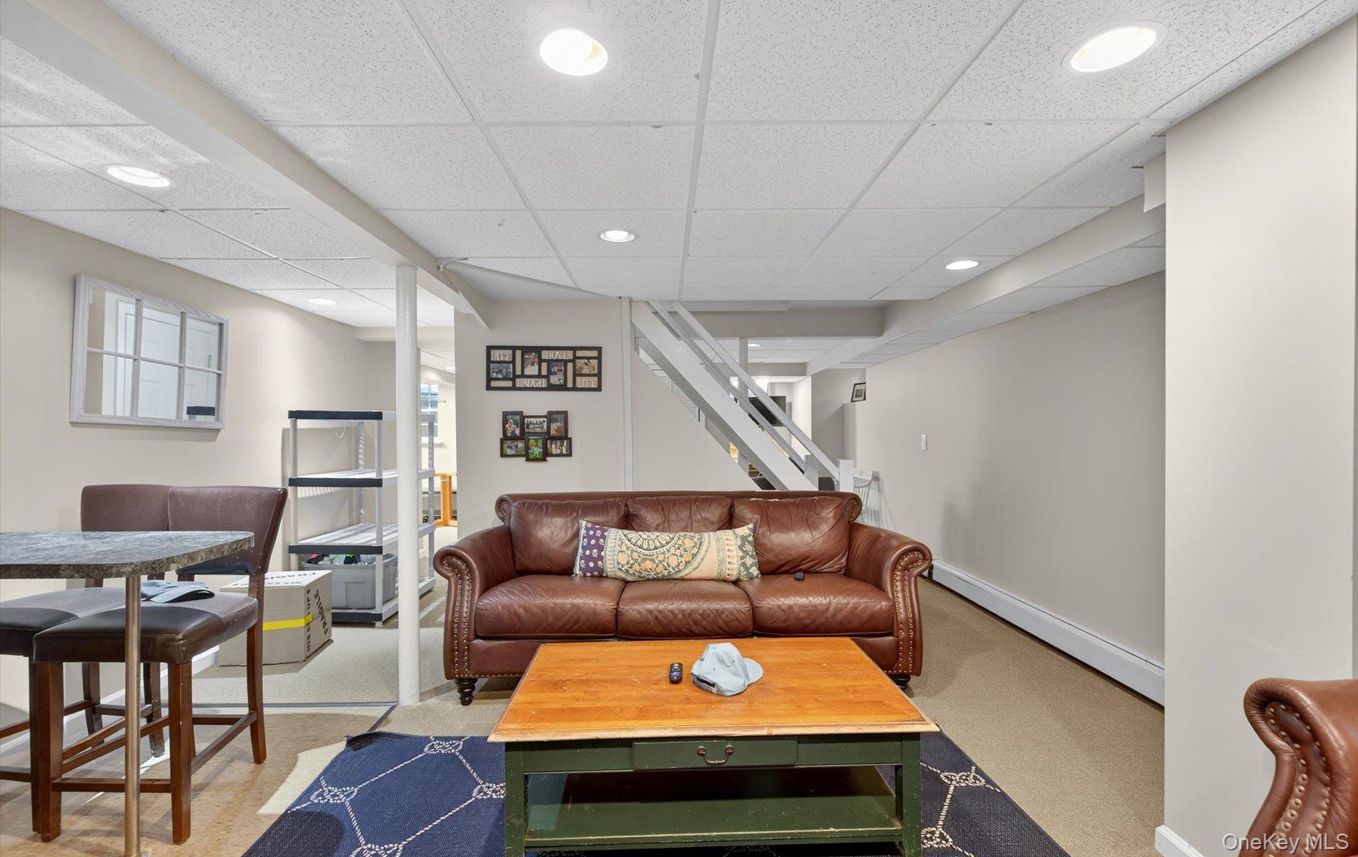 53 Eakins Road Manhasset, NY 11030 - Photo 30 of 34 a living room with furniture and a wooden floor